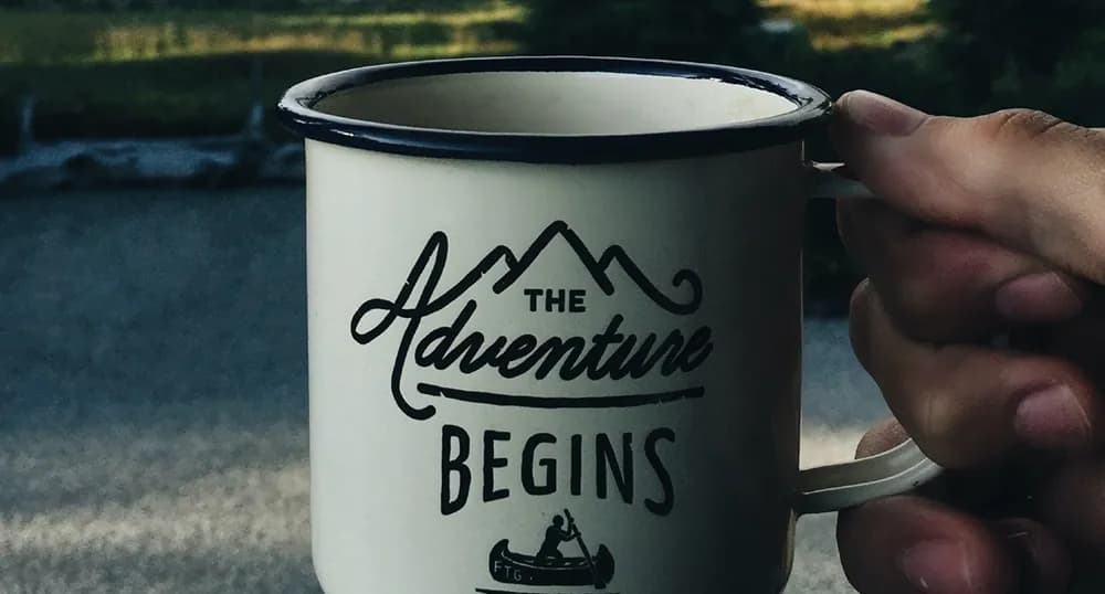 Mug that reads "The Adventure Begins"