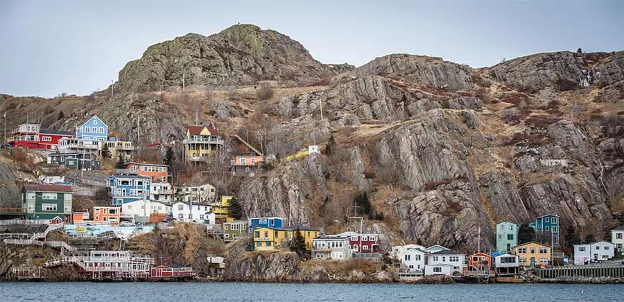 Rocky coast with colorful maritime houses in Newfoundland, Canada