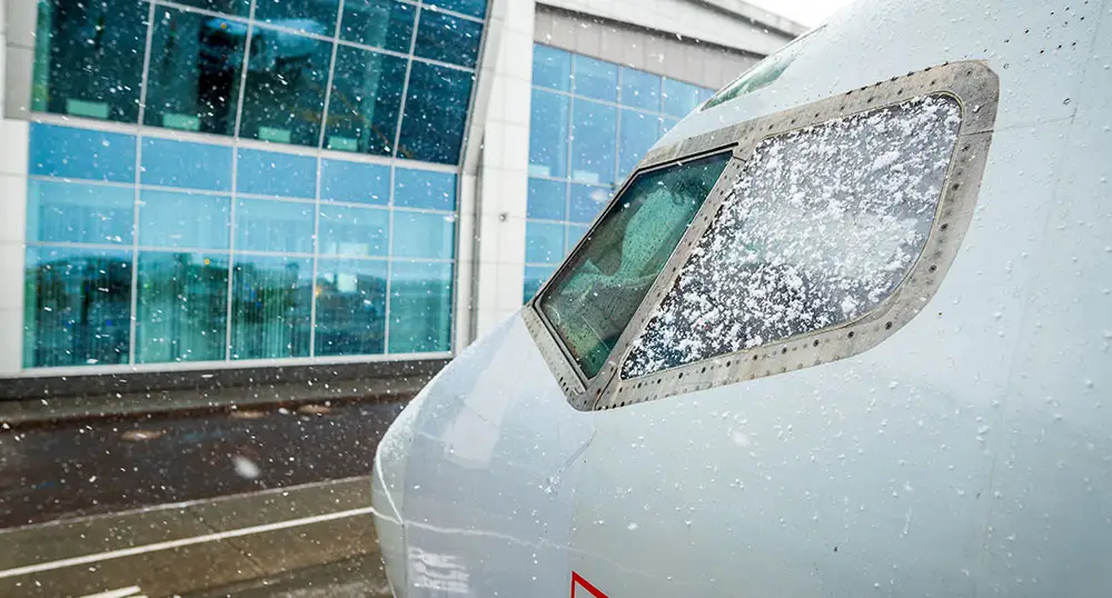 Snow on the cockpit window of an airplane