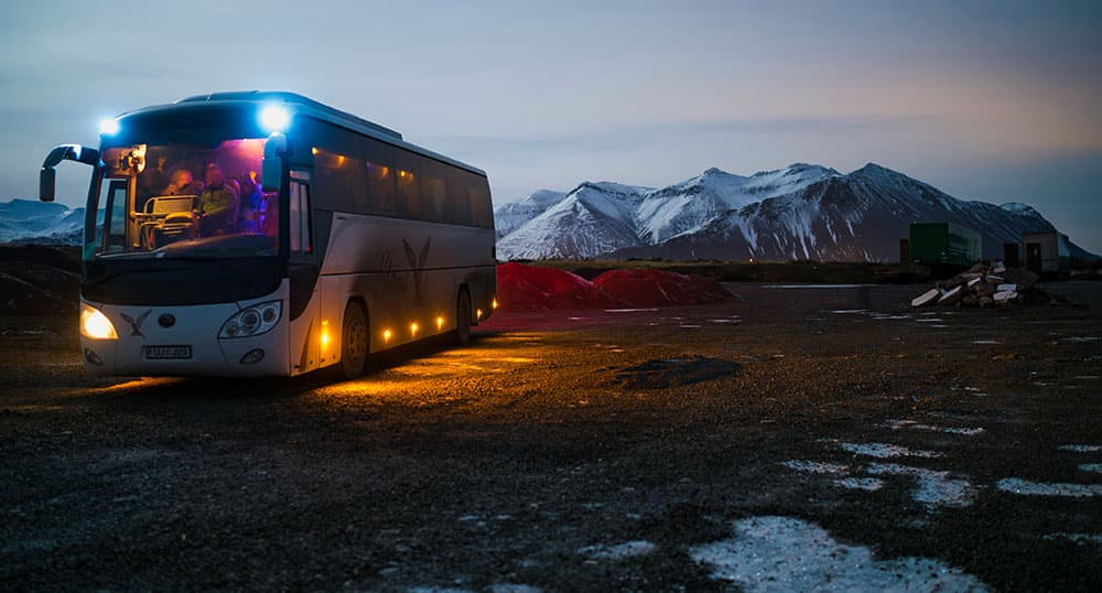 Tour bus driving in the mountains at twilight